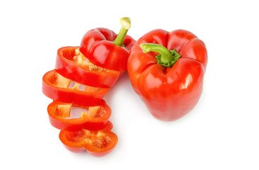 fresh red bell pepper (capsicum) and a cut one on a white background