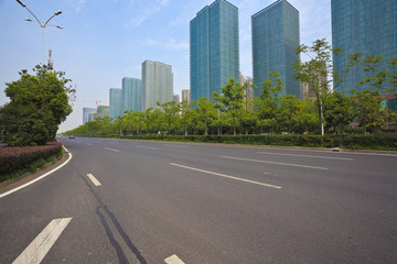 Fototapeta na wymiar Empty road surface with modern city buildings background