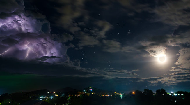 Night sky with thunderstorm, moon and stars