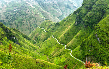 Pass road hugs the mountain plateau of Dong Van, Ha Giang, Vietnam is very treacherous, but the...