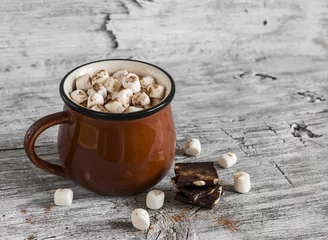 Washable wall murals Chocolate hot chocolate with marshmallows in a ceramic cup on bright wooden surface