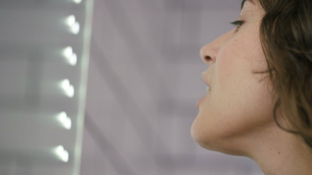 4K Close shot of woman using dental floss in her bathroom, shot on Red Epic Dragon
