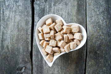 brown sugar cubes in a heart-shaped bowl