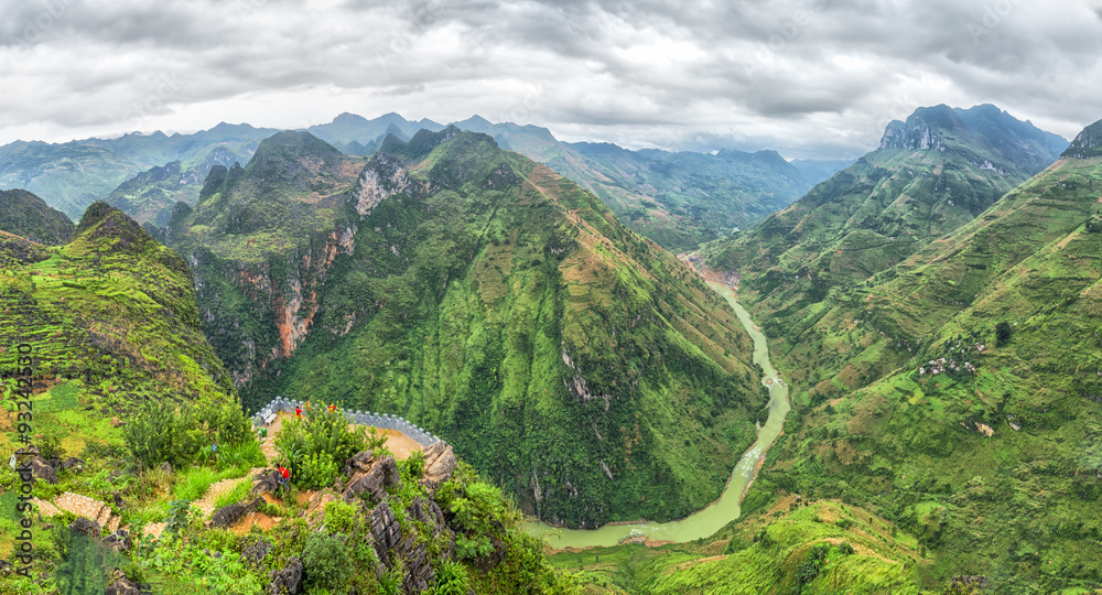 Wall mural Nho Que river valley on the rocky plateau of Ha Giang followed hills covered with green grass and cloud cover make nature more majestic than - Wall murals