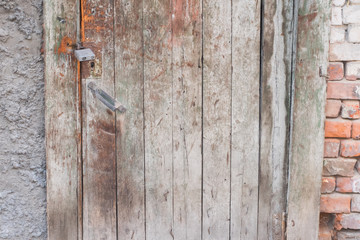 Old wooden door in the evening. The texture and color of the door.