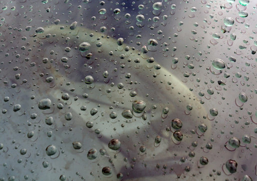 Rain drops on frot car window.