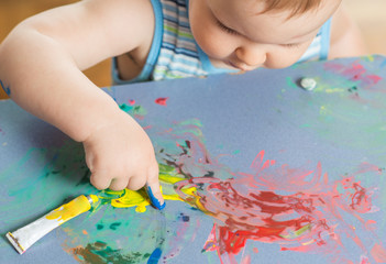 baby boy artist playing with colors