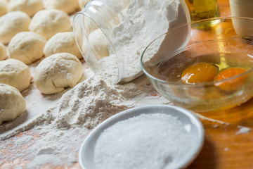 Small balls and ingredients of fresh homemade pizza dough
