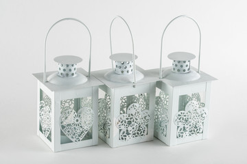 small metal candle holder in the shape of an oil lamp
