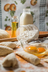 Fresh baked dough for bread or rolls and ingredients for cooking