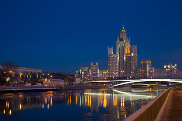 Fototapeta na wymiar One of seven Stalin skyscrapers: the high-rise building on Kotelnicheskaya Embankment in night illumination, Moscow