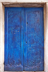 Vintage, grunge and scratched blue gate with key-hole