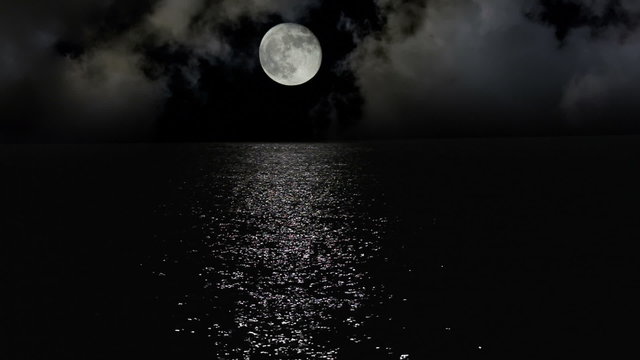 Moonlight path with low fool moon above the sea
