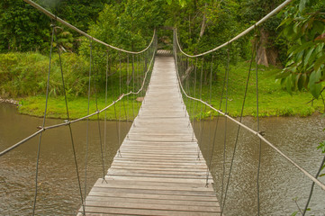 Fototapeta premium Hanging wooden bridge in the forest.