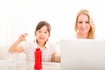 Mother and Daughter with a Laptop at home	