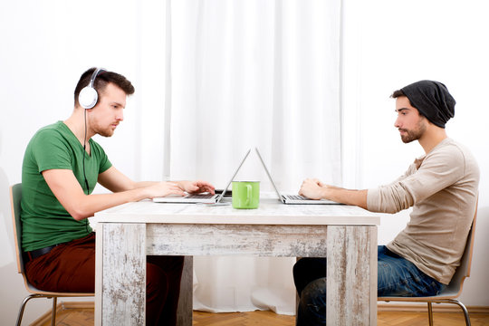 Two men working in their home office