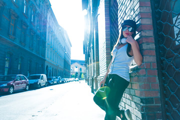 Hip hop girl with headphones in a urban environment