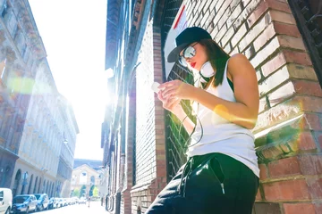 Foto op Aluminium Hip hop girl with headphones in a urban environment © Spectral-Design