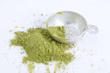 green powder heap isolated on white background