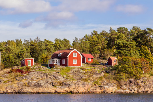 Red cottages on a rock island in in south Sweden