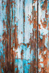 Weathered wood planks half painted in blue vertical image