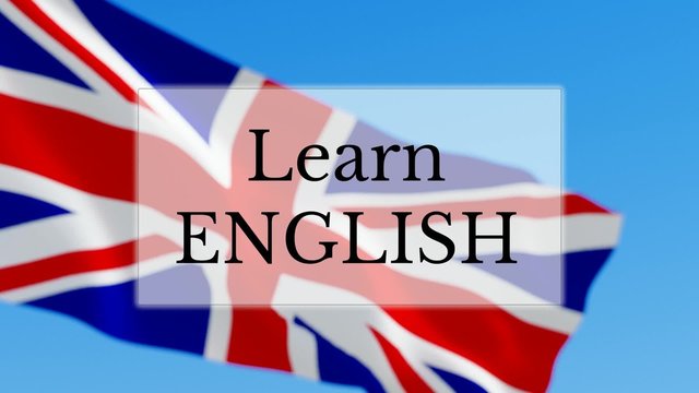 Learn English text w/ British flag background. Learn English language concept
