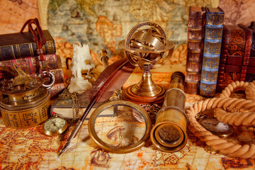 Vintage magnifying glass lies on an ancient world map