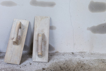 wood trowel and cement wall in construction site, trowel handhel