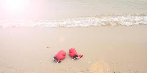 red boxing glove on the beach