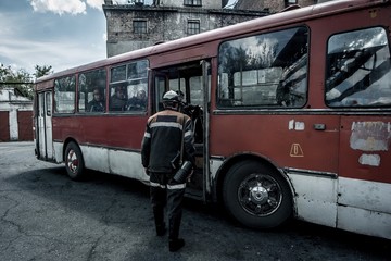 Naklejka na ściany i meble Workers in the bus at coal mine in Kazakhstan