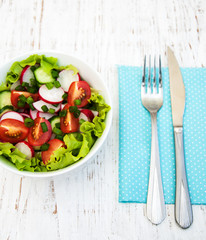 Spring salad with tomato, cucumbers and radish