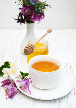 Cup of tea, honey and flowers