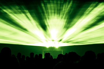 Laser show rays in green colors. Best visual show with a crowd silhouette and great laser rays for e.g. an illustration background of an invitation flyer