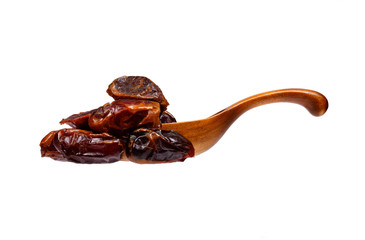 Dates in the wooden spoon, isolated on white background.
