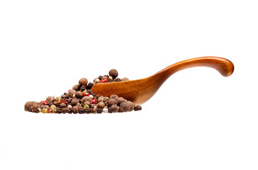 Mix of dried peppers in the wooden spoon, isolated on white back