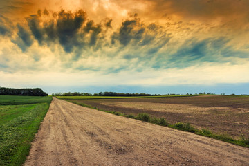 Dirty road to dramatic sky
