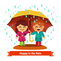 Boy and girl standing in the rain under umbrella