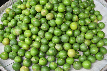 Stack of limes on display at market