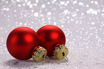 Twee rode kerstballen met glitters op de achtergrond
