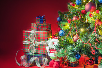 Decorated christmas tree with gift boxes and Santa Clus toy