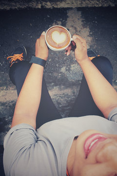 Woman drinking latte art coffee