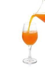 Glass and pitcher of orange juice isolated on white background