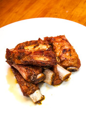 Roasted pork ribs on a white plate