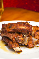 Roasted pork ribs on a white plate