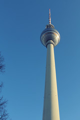 Obraz premium Part of a Berlin's television tower with a ball and spire against the blue cloudless sky