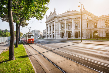 Wiener Ringstrasse with Burgtheater and tram at sunrise, Vienna, Austria