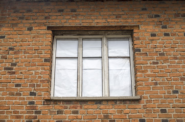 Fototapeta na wymiar Window and wall of old brick house