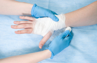 Surgeon bandaging arm