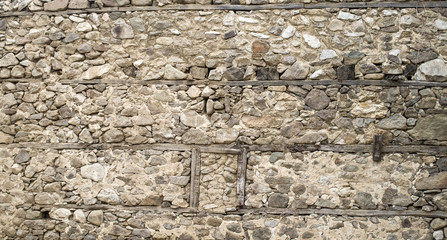 Old stone wall with walled window closeup