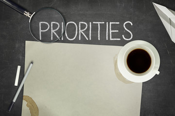Priorities concept on black blackboard